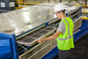 Worker using segmented screen panels for easy access into the screener machine.