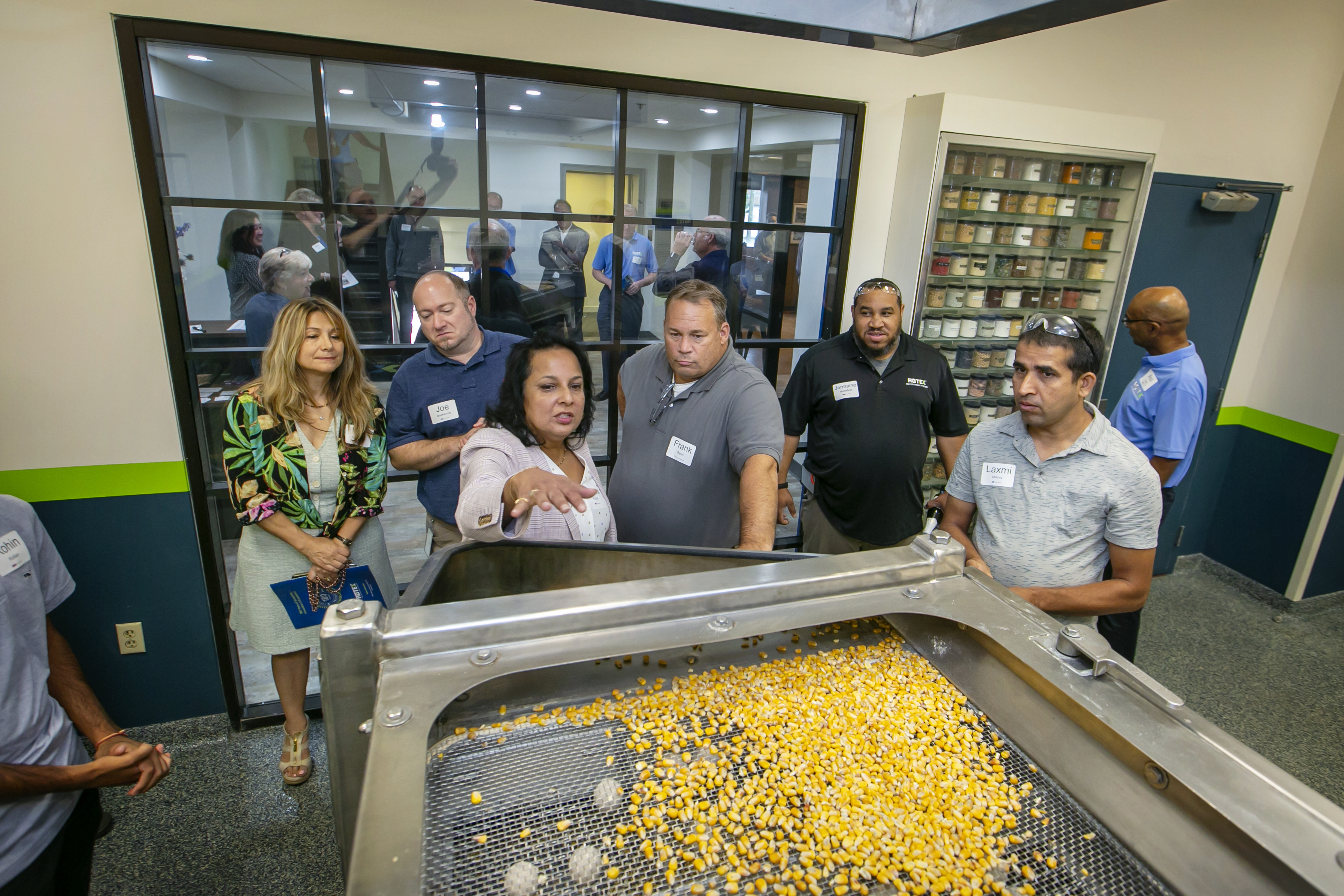 A group of observers watching a Rotex screener in operation.