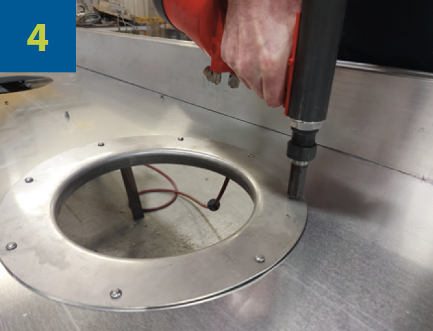 Industrial worker fixing the formed ring with 8 rivets.